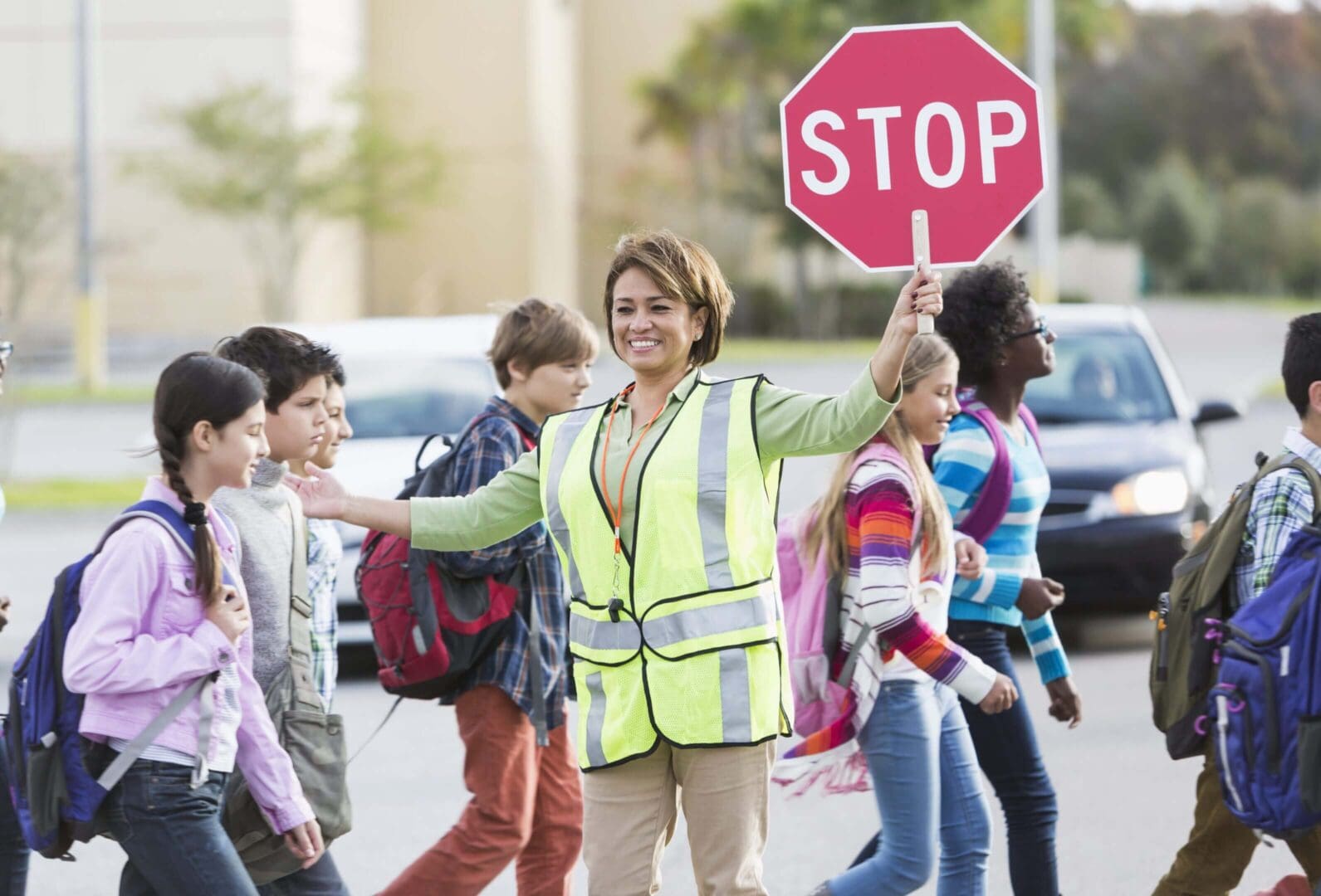 Crossing guard helping children cross the street safely.