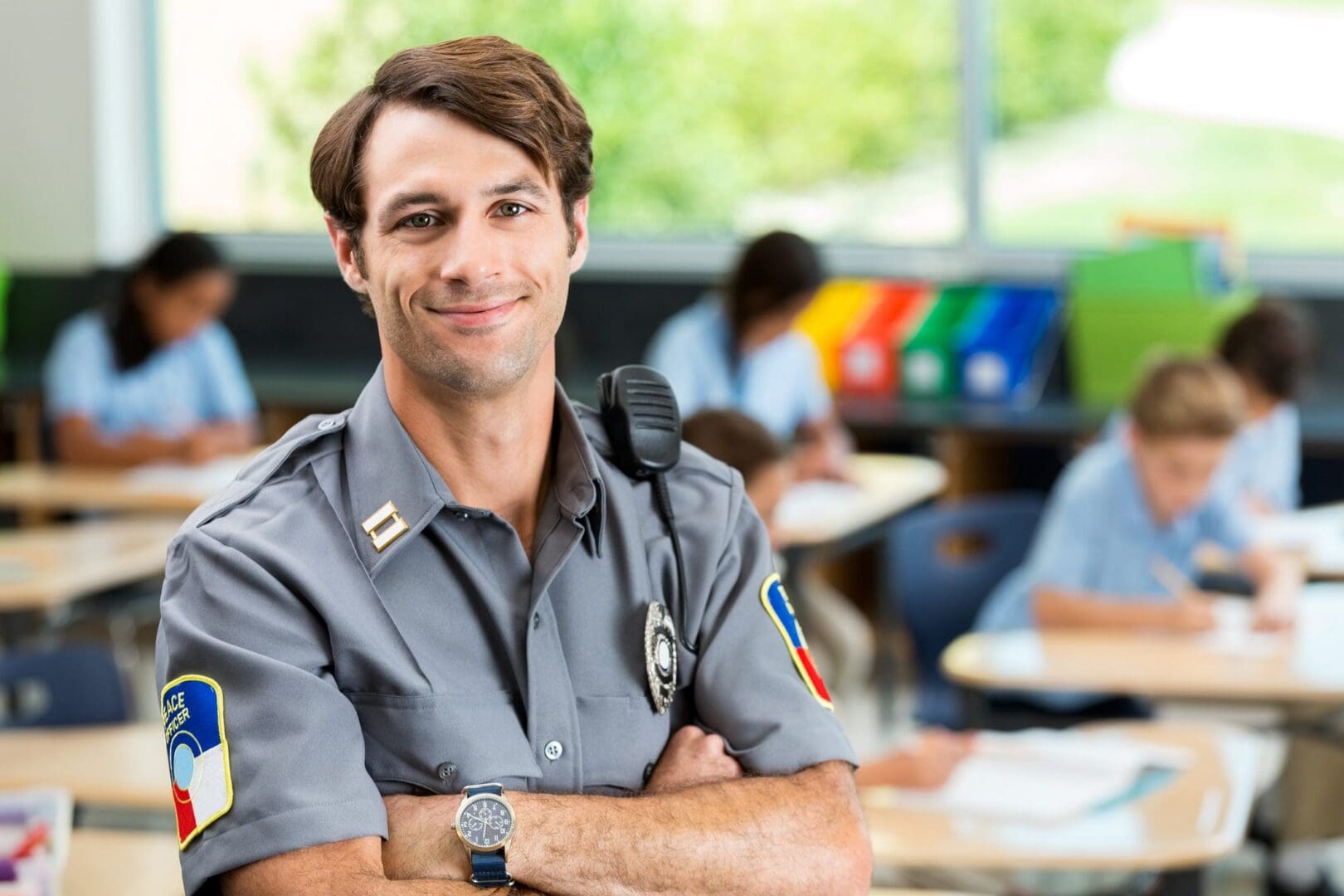 Smiling security officer in a classroom.