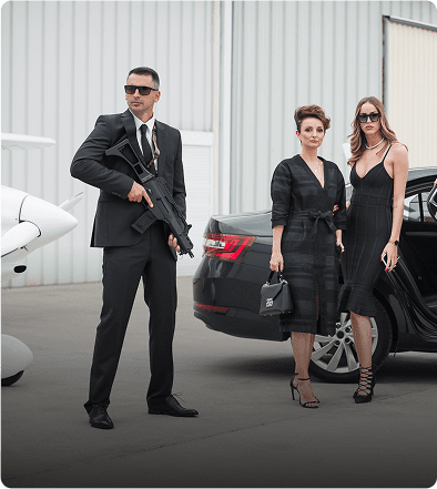Three people in formal attire near vehicle.