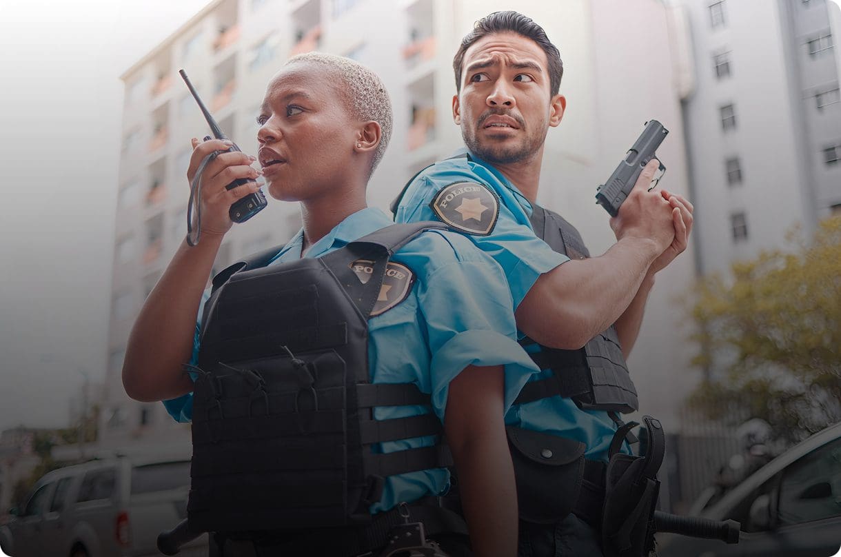 Two police officers with radio and gun.
