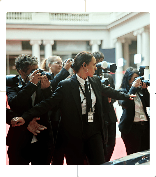 Security managing paparazzi at a red carpet.