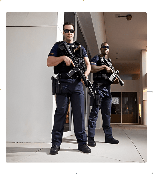 Two armed security guards in uniform standing.