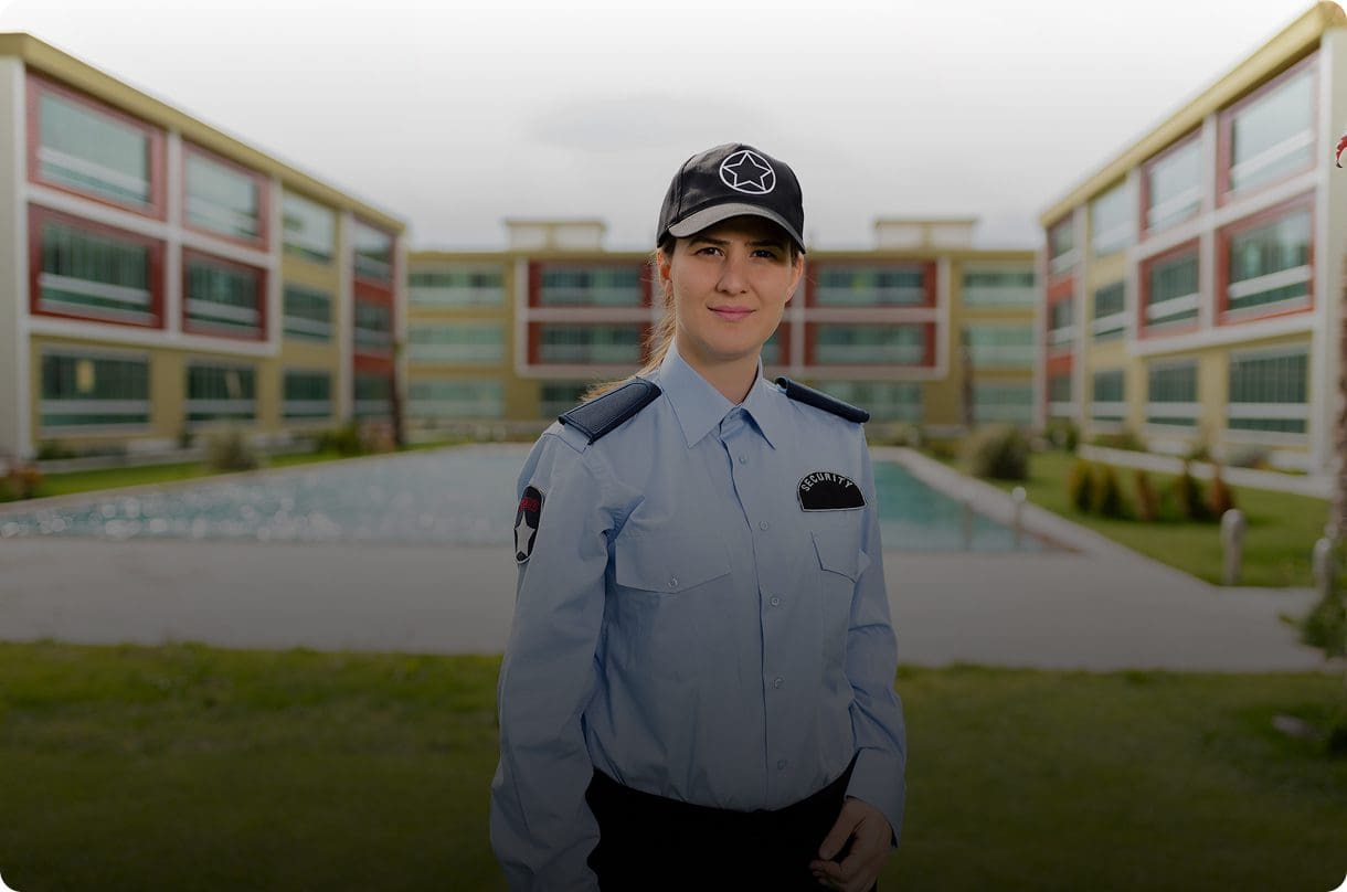 Security officer standing in front of building.